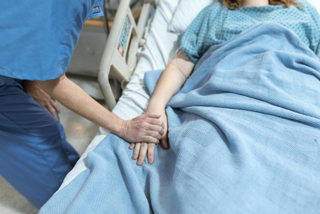 nurse holding patient's hand